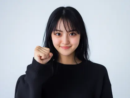 笑顔で拳を握る日本人女性のポートレート